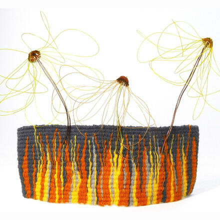 Woven tapestry of yellow, orange and grey wools with woven flowers sitting above on wire stems