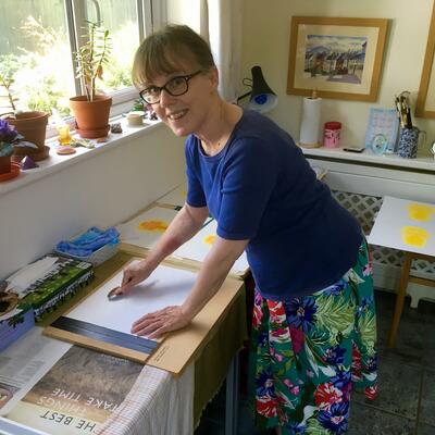 Teresa Newham hand printing a reduction linocut print