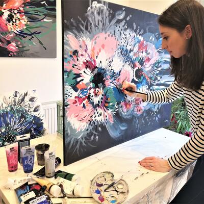 Abstract Artist Judy Century painting a large, vibrant, expressive hibiscus flower