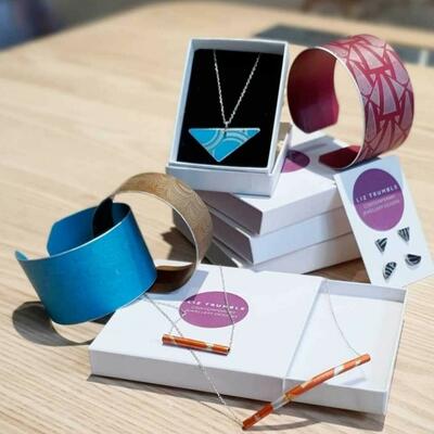 Selection of anodised aluminium Jewellery, including necklaces, cuff bangles and earrings, bright vibrant colours blues and reds
