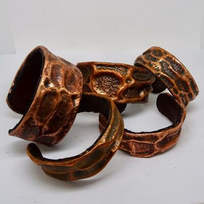 Copper cuff bangles lined with leather.