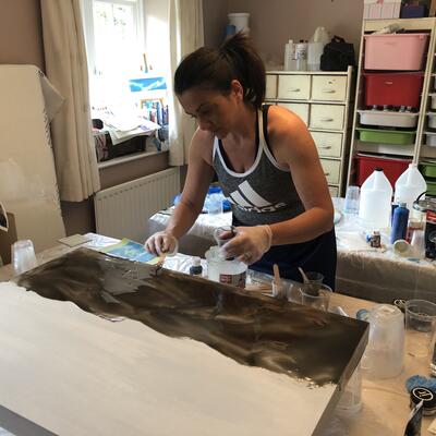 Applying the first layer of tinted resin onto a wood panel