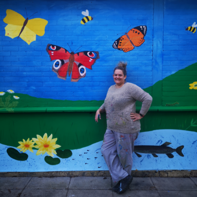 Anna with school mural
