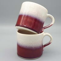 Red and white stoneware mugs