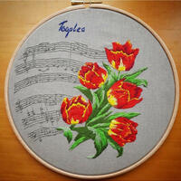 Hand embroidered picture of tulips against a musical score by Kat Kerr