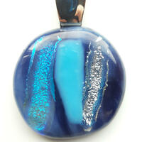 Fused glass pendant in shades of blue and silver dichroic