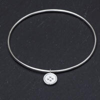 Sterling silver bangle with button charm