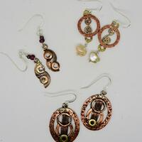 Copper and brass earrings made from washers., with sterling silver ear wires.