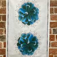 tea towel with a design of a digital collage of pine cones and wild flowers