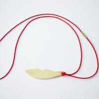Gold lips necklace by Teague
