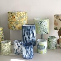 A selection of printed lampshades and tea lights