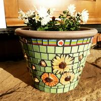 Plant pot mosaiced with glazed ceramics & glass.