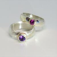 Amethyst and garnet stones set in gold on silver rings