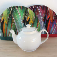 Red and green phormium tea cosies