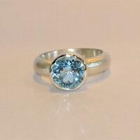 satin finished, silver ring with large sky blue topaz.