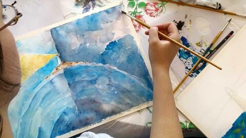 Artist painting with watercolours