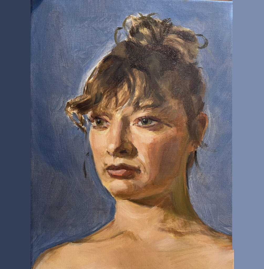 Tanned woman with sunlit hair tied up.