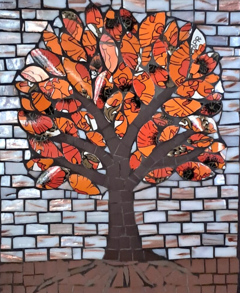 Framed 'Flame Tree' mosaic with vibrant orange & black leaves made from 'Meakin Poppy' ceramics. The trunk provides contrast in both colour & material, being of unglazed dark brown ceramic. The background of gilded white glass suggests evening & helps to highlight the tree.