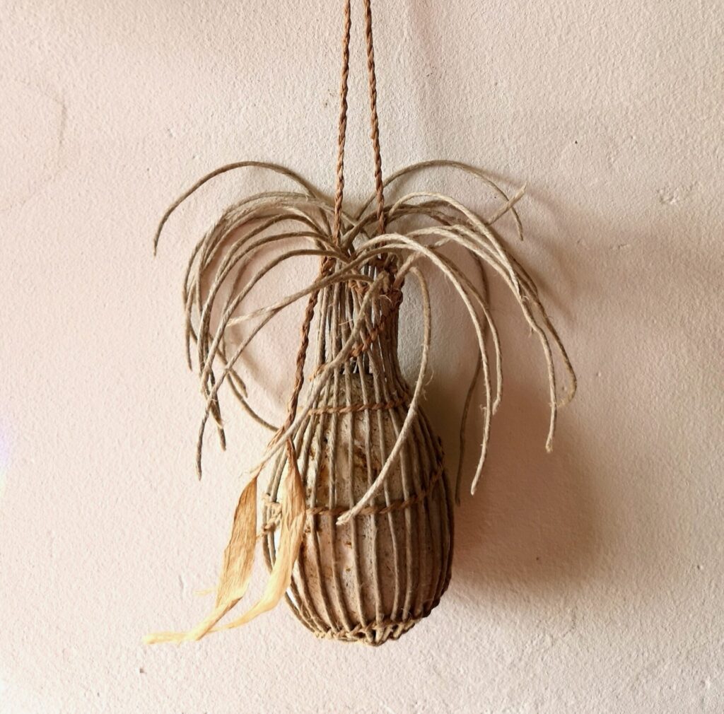 Twined flint pebble woven with linen, paper twine hanging cord