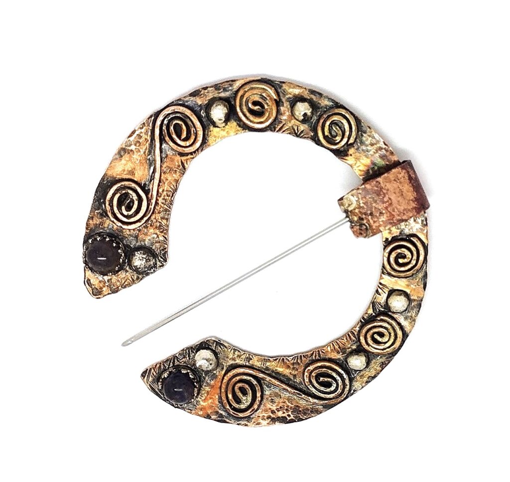 Celtic pennanular brooch, with amethysts and garnet. Mixed metals.