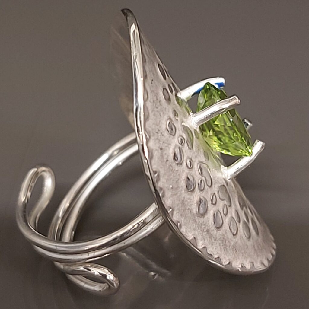 Cut peridot set in sterling silver on an adjustable ring