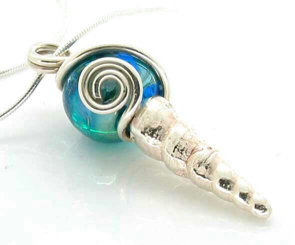 Silver shell with glass blue glass bead